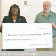 Eula Tatman of the Community Foundation of Calhoun County receives gift from Tom Potts, Jr.